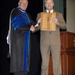 CGSC Dean of Academics Dr. Wendell C. King presents Dr. Dr. Phillip G. Pattee with his award for the U.S. Army Training and Doctrine Command's "Educator of the Year" during the College graduation ceremony June 12, 2015.