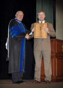 CGSC Dean of Academics Dr. Wendell C. King presents Dr. Dr. Phillip G. Pattee with his award for the U.S. Army Training and Doctrine Command's "Educator of the Year" during the College graduation ceremony June 12, 2015.