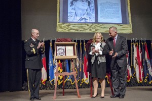 Brig. Gen. John S. Kem, Ms. Cicile Rainey, and Col. (Ret.) David Moore unveil the plaque honoring Rainey and Moore's father, Lt. Gen. Hal Moore, that will be placed in the Fort Leavenworth Hall of Fame during ceremonies during ceremonies at the Lewis and Clark Center today. (photo by Dan Neal)