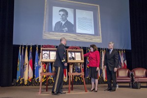 Brig. Gen. John S. Kem, Ms. Anne Harris, and Gary Sinise unveil the plaque honoring Harris's late husband, Lt. Col. Boyd M. (Mac) Harris, that will be placed in the Fort Leavenworth Hall of Fame during ceremonies during ceremonies at the Lewis and Clark Center today. Sinise is Harris's brother-in-law. (photo by Dan Neal)