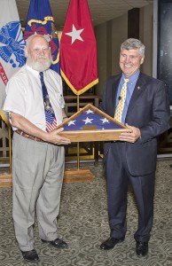 Brig. Gen. (Ret.) John Schmader presents Col. (Ret.) Lynn Rolf with his retirement flag during his retirement ceremony Aug. 4. – Click the image for more photos from the ceremony.