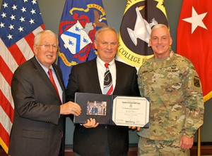 Mr. Terry Dunn, the retired president/CEO of JE Dunn Construction in Kansas City, center, receives a certificate of completion of the National Security Roundtable Program from CGSC Foundation Chairman Lt. Gen. (Ret.) John Miller, left, and Brig. Gen. Eugene (Gene) J. LeBoeuf, Army University’s Deputy Commanding General and Executive Vice Provost for Academics Affairs. – Click the image for more photos (including all the graduation photos) from day two of the program.