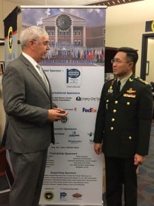 Foundation CEO Doug Tystad presents Gen. Surapong with a Foundation coin.