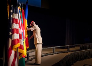 Capt. Amir Nimery posts the flag of Chad during the International Flag Ceremony Aug. 14
