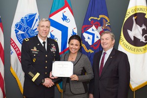CGSC Deputy Commandant Brig. Gen. Scott L. Efflandt, left, and CGSC Foundation Chair Michael Hockley, right, present an NSRT certificate of completion to Michelle Kay, vice president and General Manager, Enterprise Holdings.
