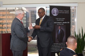 CGSC Foundation President/CEO Doug Tystad presents Gen. Lloyd J. Austin III, U.S. Army, Ret., with a Colin L. Powell Lecture Series silver commemorative coin for his support of the program.
