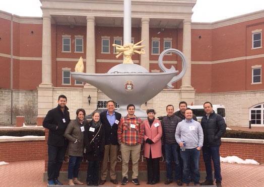 Executives from The Miller Group gather outside the Lewis and Clark Center by the iconic Leavenworth Lamp for a group photo during their tour Feb. 27, 2019.