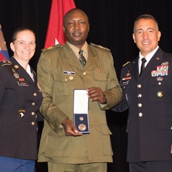 ommand Sgt. Maj. Teresa Duncan, Army University, and Brig. Gen. Steve Maranian, deputy commandant of the Command and General Staff College, present the CGSC International Graduate Badge to Ugandan Maj. Sam Nsubuga Rugwira during the Class of 2019 International Officer Badge Ceremony June 13, 2019, at the Lewis and Clark Center. (photo courtesy ArmyU Public Affairs)