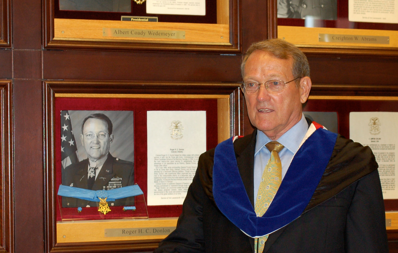 After the Aug. 11, 2008, ceremony in which he gifted his Medal of Honor to the College, Col. (Ret.) Roger Donlon poses for a photo in front of his Fort Leavenworth Hall of Fame shadow box in the atrium of the Lewis and Clark Center.