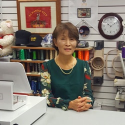 MNJ-Emblem-250px MNJ Emblem owner Kil Sampson in her shop in the Fort Leavenworth Post Exchange.