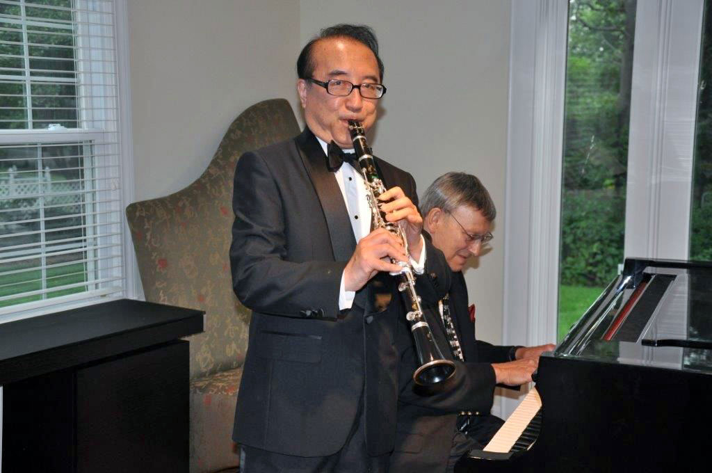 Board member and long-time friend of the Foundation Benny Lee plays the clarinet at a reception he hosted for the CGSC Foundation.