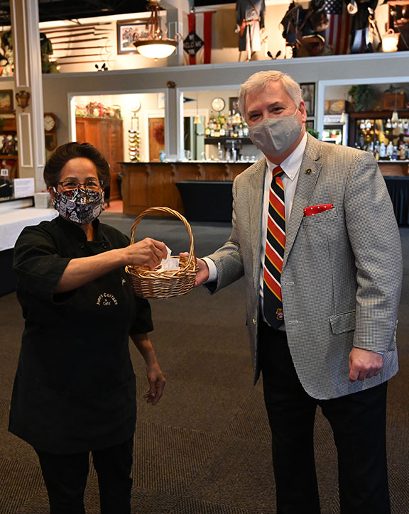 June Meyer, the owner of June's Northland, assists Foundation President/CEO Rod Cox with drawing the winning raffle tickets for the Foundation’s 2020 holiday ornament.