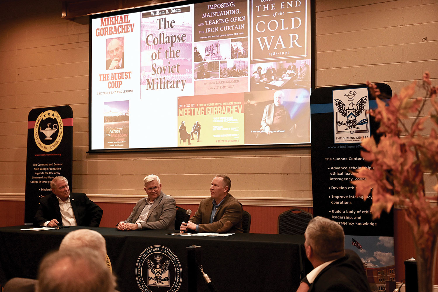 Robert Davis, right, Ph.D., Director, Goodpaster Scholars, School of Advanced Military Studies, describes some of the conditions leading to the decline of the Soviet Union during the kickoff of the Cold War Symposium on Nov. 9, 2021, at June’s Northland in Leavenworth, Kansas. Hosted by the CGSC Foundation’s Simons Center, the symposium will continue from December 2021 through February 2022 with virtual presentations each month by panels of experts. At Davis’ right is Col. (Ret.) Jon House, center, Ph.D., Professor Emeritus, CGSC Department of Military History, and Simons Center Bob Ulin, left.