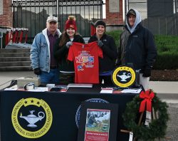 From left, CGSC Foundation President/CEO Rod Cox, Paige Cox, Foundation Director of Operations Lora Morgan, and Combined Arms Center G-1 Col. Mark Morgan, prep the Foundation's information table prior to the start of the KU Vets Day 5K on Nov. 14, 2021.