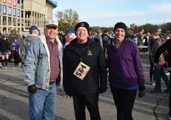 Foundation President/CEO Rod Cox, left, spends a few minutes with the Foundation's runners in the KU Vets Day 5K on Nov. 14, 2021 – Foundation Trustee Maj. Gen. (Ret.) Clyde “Butch” Tate, II, center, and Foundation Director of Operations Lora Morgan.