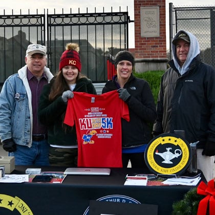 KU-Vets-Day-5K-420px From left, CGSC Foundation President/CEO Rod Cox, Paige Cox, Foundation Director of Operations Lora Morgan, and Combined Arms Center G-1 Col. Mark Morgan, prep the Foundation's information table prior to the start of the KU Vets Day 5K on Nov. 14, 2021.