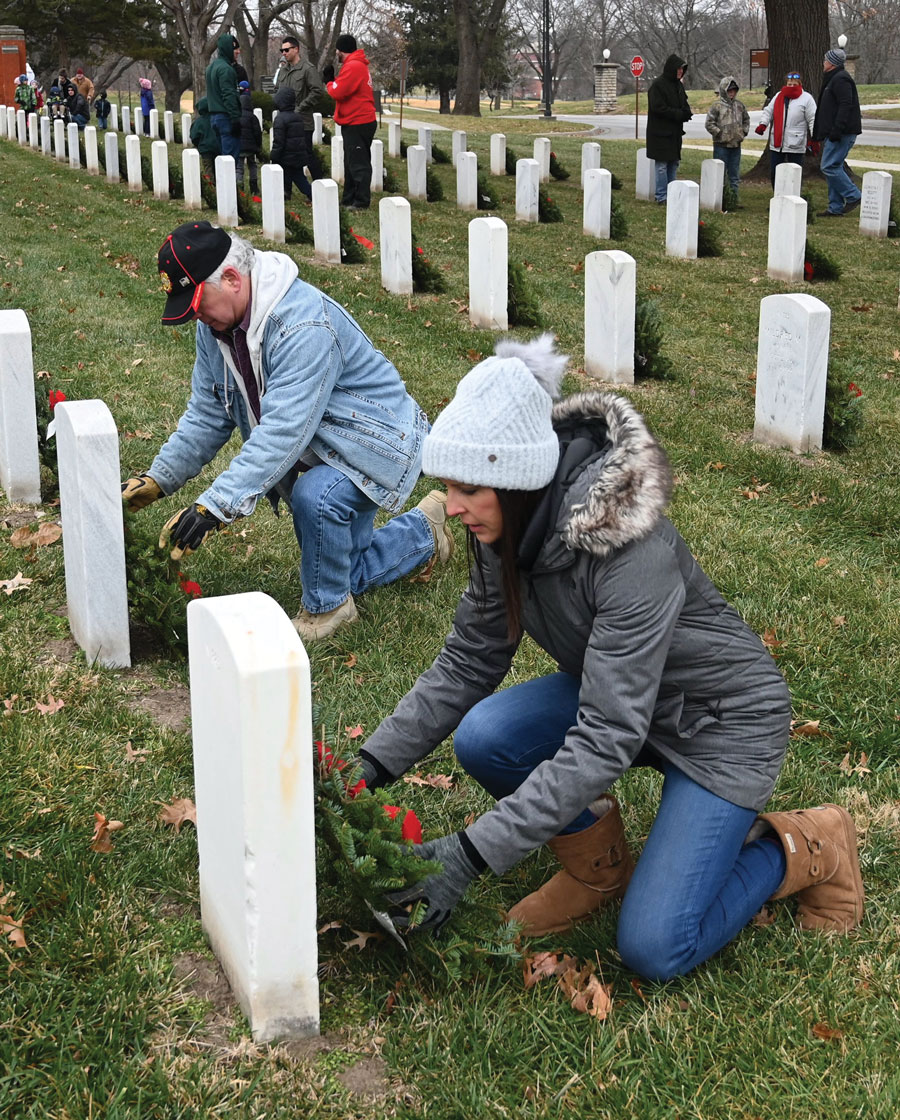 CGSC Foundation President/CEO Rod Cox, left, and Director of Operations Lora Morgan lay wreaths during the national Wreaths Across America Day, Dec. 18, 2021, at the Fort Leavenworth National Cemetery.