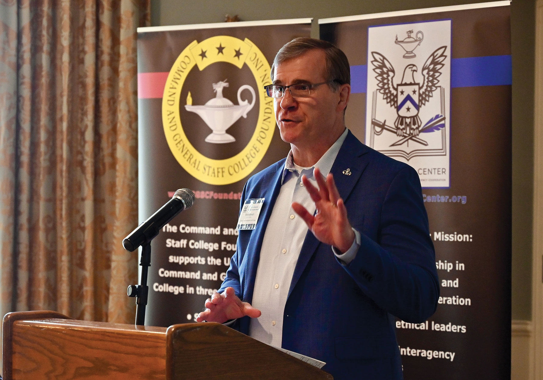 Retired Col. Steve Banach provides his presentation on virtual warfare for the Arter-Rowland National Security Forum luncheon event on Feb. 24, 2022, at the Carriage Club in downtown Kansas City.