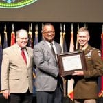 220404-faculty-awards-420px Dwayne K. Wagner from the Department of Joint, Interagency and Multinational Operations in the Command and General Staff School, center, receives his Silver Pen Award during the faculty awards ceremony in the Lewis and Clark Center on April 4, 2022, from CGSC Dean of Academics Dr. Jack Kemp, left, and CGSC Deputy Commandant Maj. Gen. Donn H. Hill. Wagner is a member of the CGSC Foundation board of trustees.