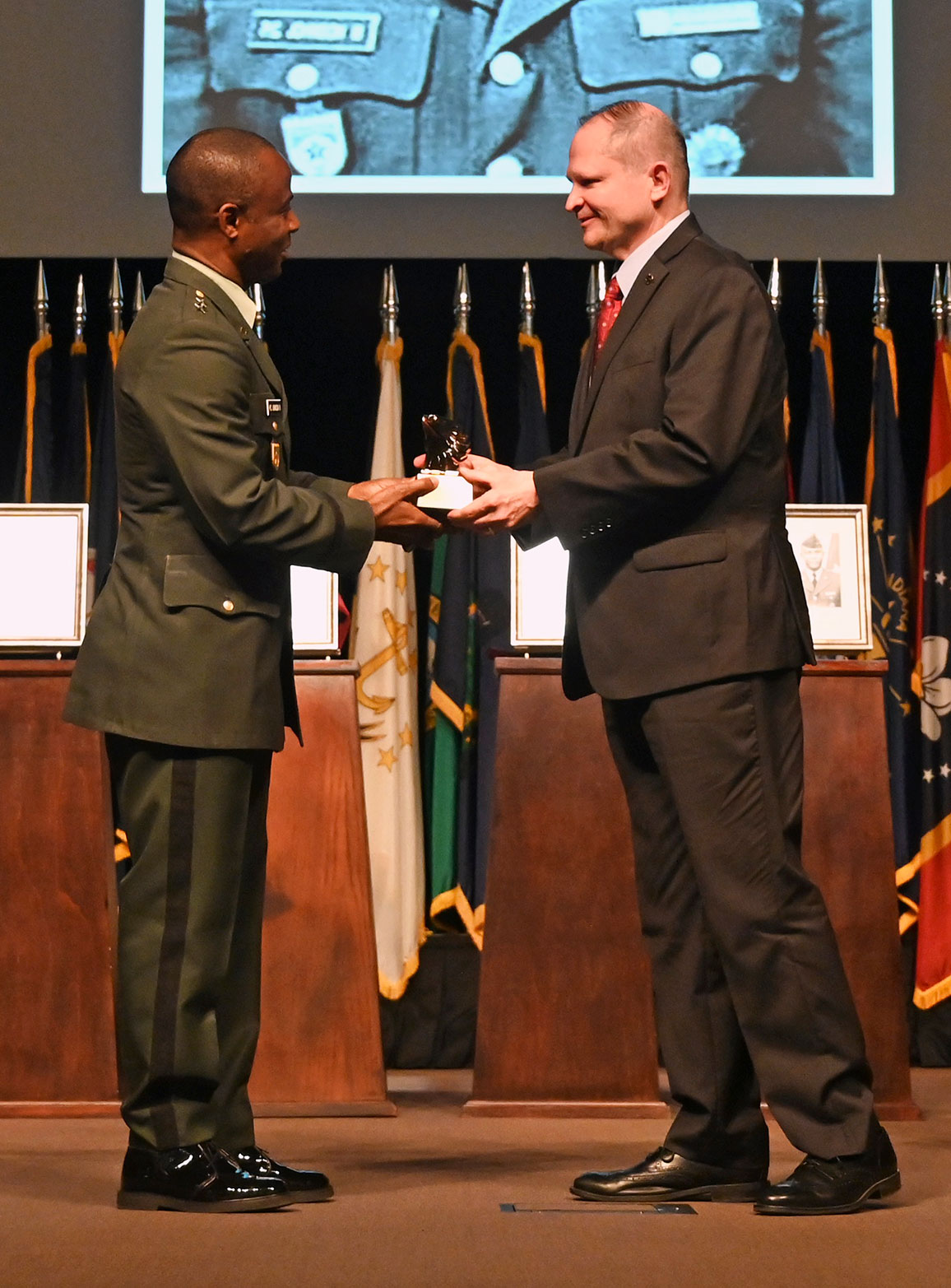 CGSC Foundation Chairman Brig. Gen. (Ret.) Bryan W. Wampler, right, presents Maj. Gen. Prince Charles Johnson, III, Chief of Staff, Armed Forces of Liberia, with an eagle statuette signifying his appointment as a life constituent of the CGSC Foundation during the International Hall of Fame induction ceremony April 12, 2022, at the Lewis and Clark Center, Fort Leavenworth, Kansas.