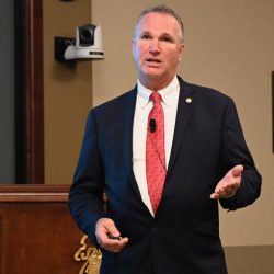 Mr. Larry A. Hisle, executive director of the Greater Kansas City Federal Executive Board, presents the eighth and final InterAgency Brown-Bag Lecture for academic year 2022 in the Arnold Conference Room of the Lewis and Clark Center on May 18, 2022.