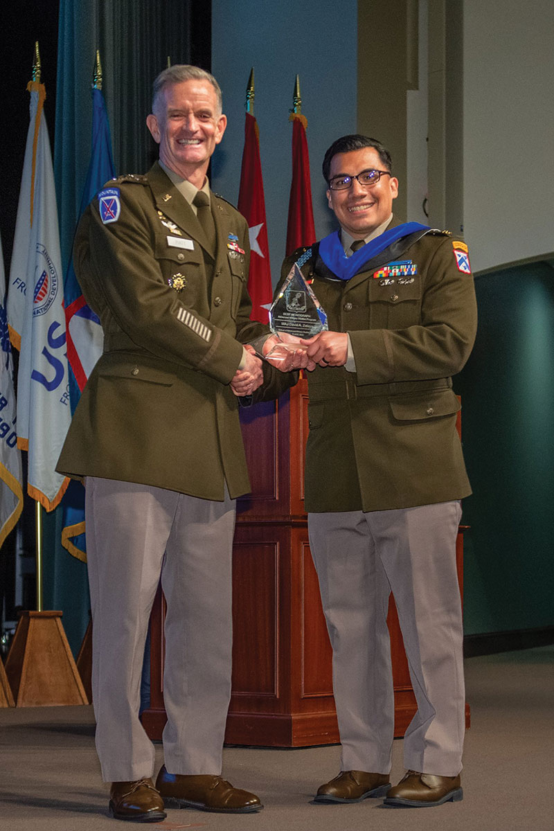 Maj. David A. Zelaya receives the award for the best Advanced Military Studies Program monograph from graduation guest speaker Lt. Gen. Walter E. Piatt, Director of the Army Staff, during the SAMS graduation ceremony May 26, 2022.
