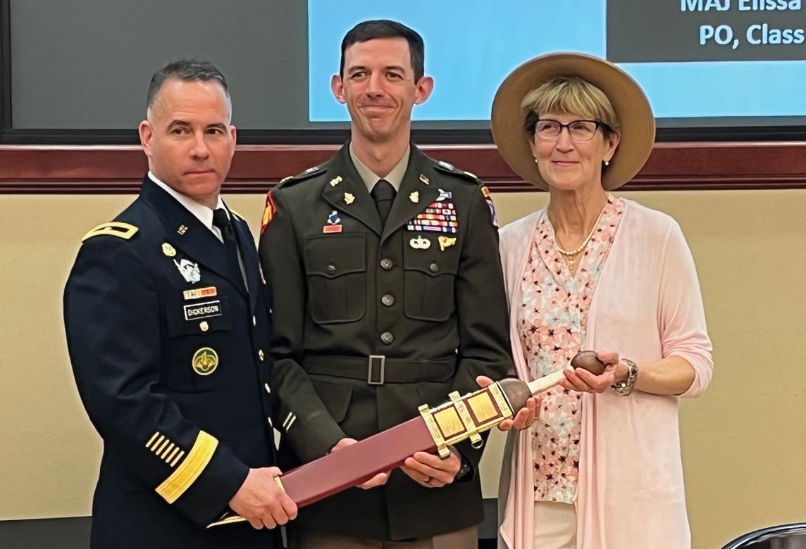 Maj. Joseph A. Bedingfield, center, poses for photos after receiving the LTC Ronald C. Ward Distinguished Special Operations Forces Student Award, a Roman Gladius sword, signifying his selection as the top Special Operations Forces student for the Command and General Staff Officer Course Class of 2022 in a ceremony June 9 in Marshall Auditorium of the Lewis and Clark Center. Guest speaker Brig. Gen. Kelly M. Dickerson, left, deputy commanding general of the U.S. Army JFK Special Warfare Center and School at Fort Bragg, N.C., and Ms. Beth Ward, wife of the award’s namesake, presented the award. (photo by Lora Morgan, CGSCF Director of Operations)