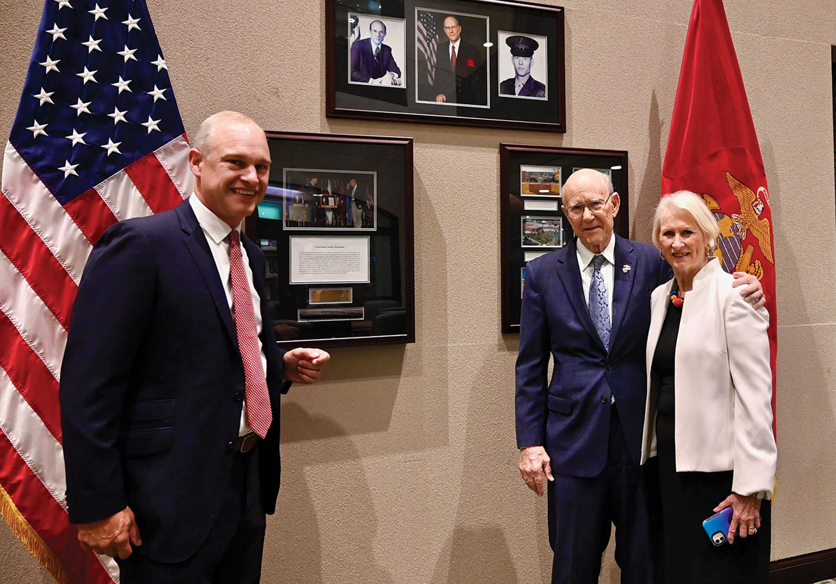 From left, Sen. Roberts' former chief of staff, attorney Chad Tenpenny, Sen. Pat Roberts and his wife Franki pose in front of the display in the "Roberts Room" of the Lewis and Clark Center. 