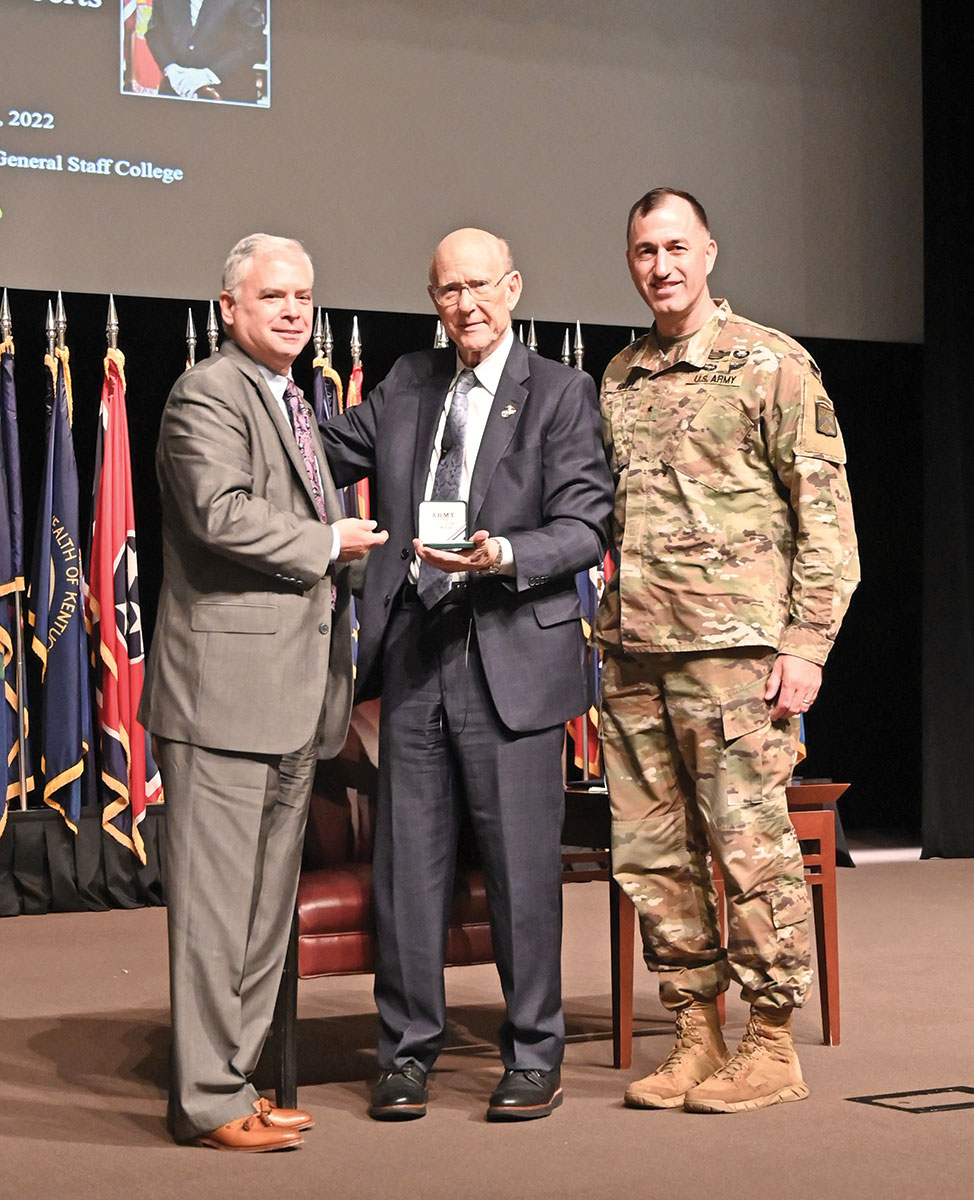 CGSC Foundation President/CEO Roderick M. Cox and CGSC Deputy Commandant Brig. Gen. David Foley present Sen. Pat Roberts with a commemorative Colin L. Powell coin in appreciation of his presentation as the Colin. L. Powell Lecture Series speaker for Academic Year 2022.