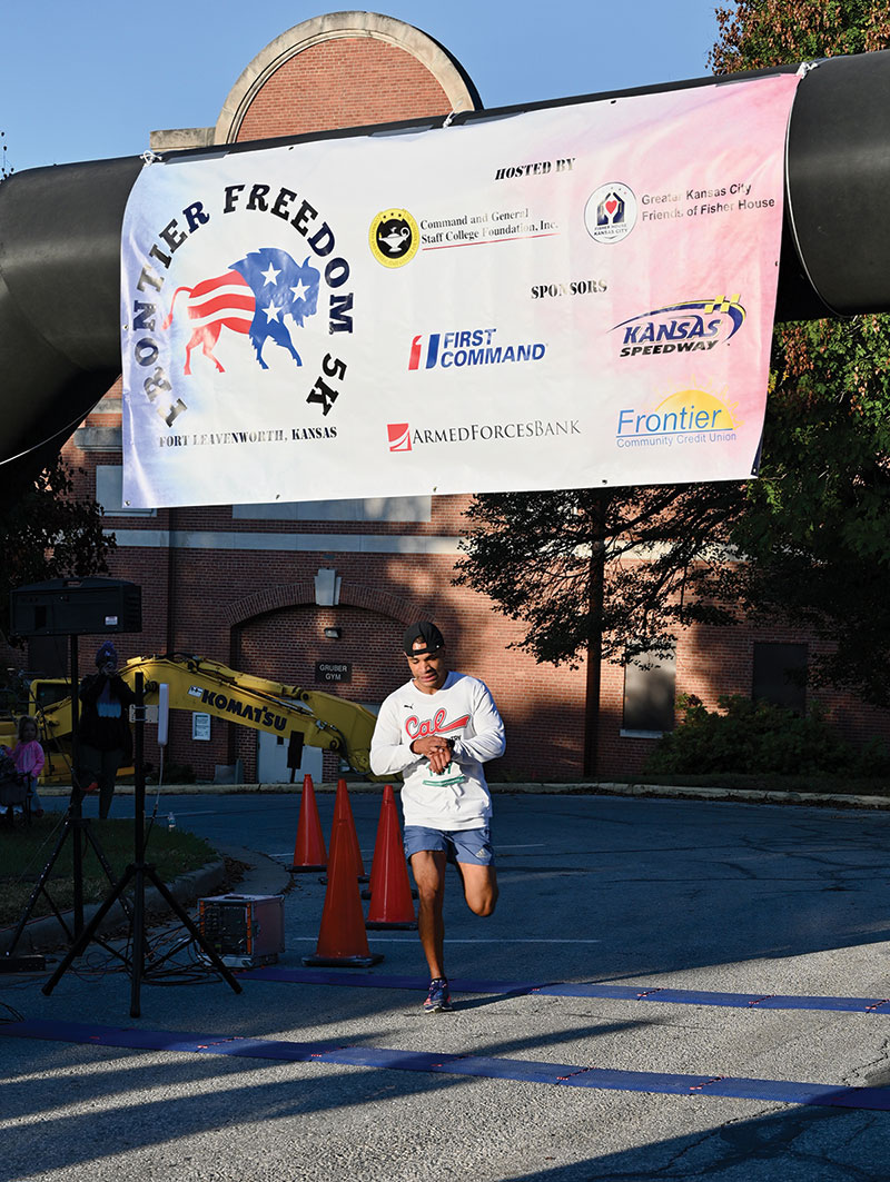 Bradley Rager crosses the finish line during the Frontier Freedom 5K Run/Walk on Fort Leavenworth on Oct. 9, 2022, hosted by the CGSC Foundation and the Greater Kansas City Friends of the Fisher House. Rager won the top overall and top male competition with a time of 18:23.