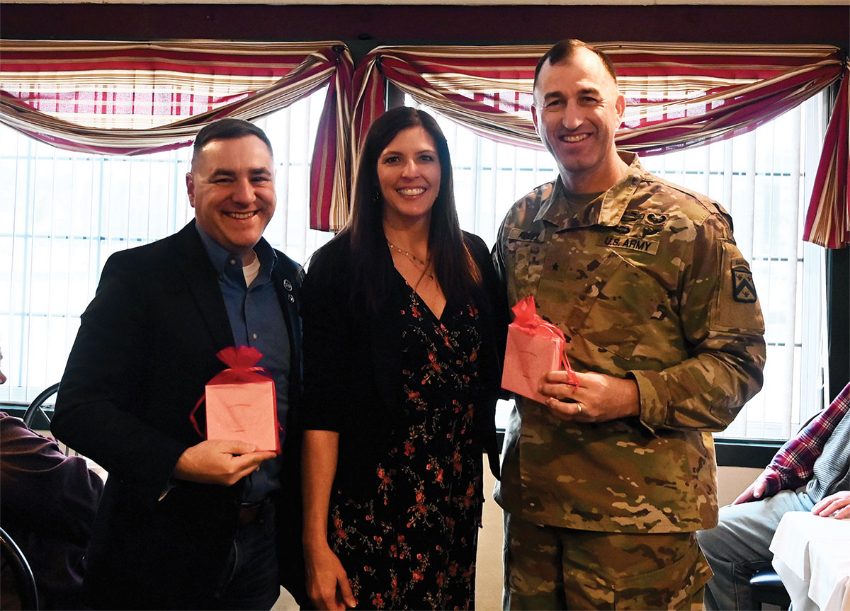 CGSC Foundation Director of Operations Lora Morgan presents Foundation holiday ornaments to door prize winners CGSC Foundation Trustee Pat Proctor, left, and Army University Provost/CGSC Deputy Commandant Brig. Gen. David Foley during the Friends of the Foundation Holiday Luncheon Dec. 16, 2022, at the Baan Thai restaurant in downtown Leavenworth, Kansas.