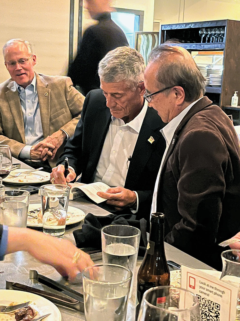 Lt. Gen. (Ret.) Robert L. Caslen, Jr., former Fort Leavenworth commander/CGSC commandant, autographs a copy of his book "The Character Edge" for CGSC Foundation Trustee Benny Lee at the Foundation dinner on March 8, 2023. (photo by Lora Morgan, CGSC Foundation)