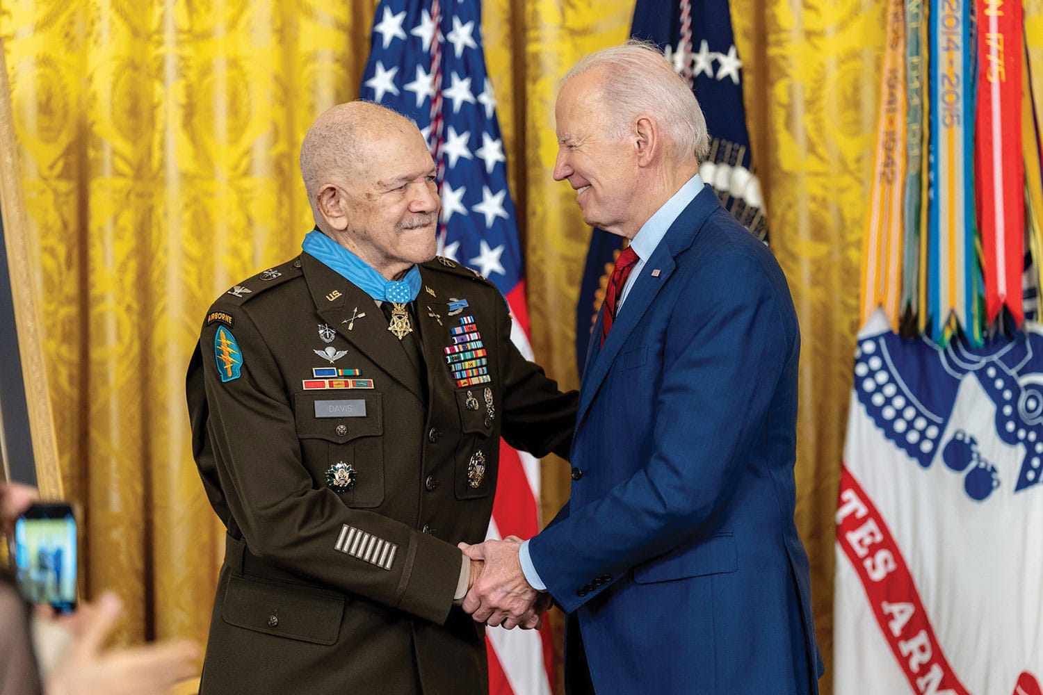 Davis receives MoH w President Joe Biden shakes the hand of retired U.S. Army Col. Paris D. Davis, after presenting him with the Medal of Honor on March 3, 2023, in the East Room of the White House. (Official White House Photo by Adam Schultz)