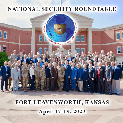 NSRT logo and dates over a group photo of the leaders, guests and student escorts in front of the Lamp of Knowledge at the entrance of the Lewis and Clark Center on Fort Leavenworth on April 18, 2023.