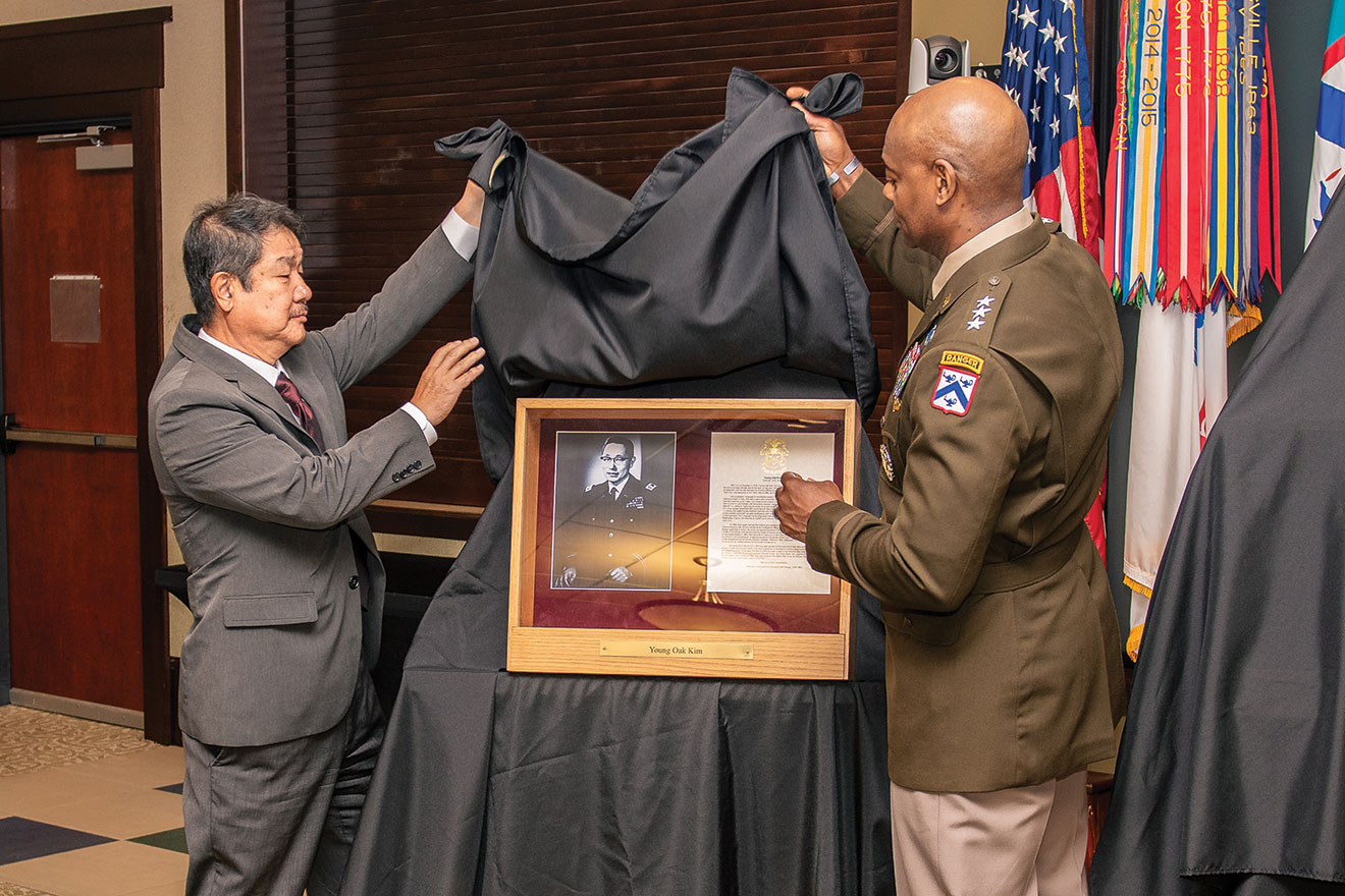 Dr. Edward Chang, professor of ethnic studies and founding director of the Young Oak Kim Center for Korean American Studies at the University of California at Riverside and Lt. Gen. Milford Beagle, Jr., reveal the shadow box that will be placed in the Fort Leavenworth Hall of Fame honoring Col. Yong Oak Kim.