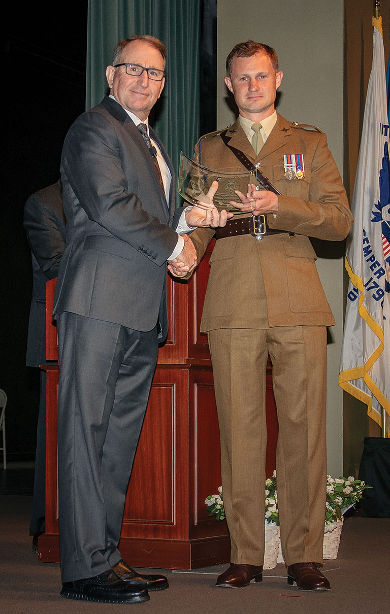 Major Edward M. Brecht, United Kingdom, receives the General Dwight D. Eisenhower Award from Gen. (Ret.) Robert B. Abrams, honoring him as the top international student in Command and General Staff Officers Class of 2023 at graduation, June 9, at the Lewis and Clark Center.