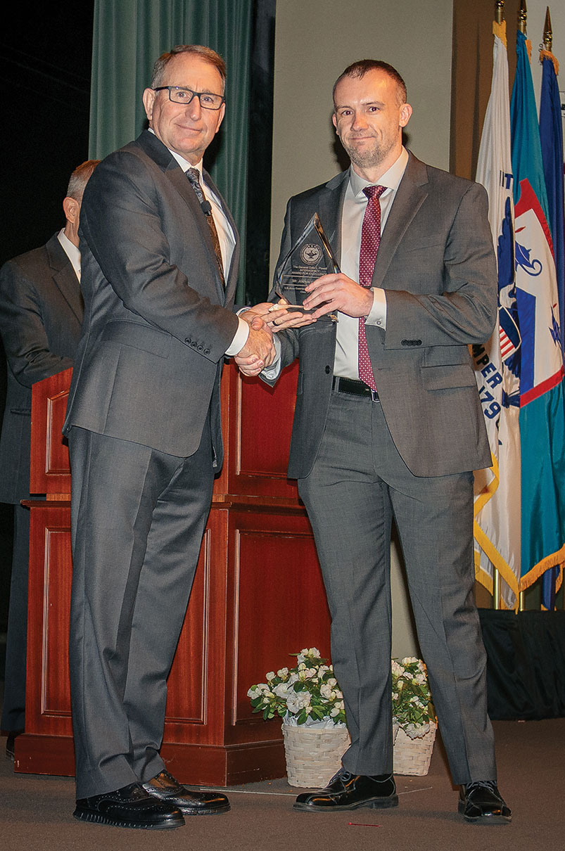 Joshua W. Smith, Department of State, receives the General Colin Powell Interagency Award from Gen. (Ret.) Robert B. Abrams, honoring him as the top interagency student in Command and General Staff Officers Class of 2023 at graduation, June 9, at the Lewis and Clark Center.