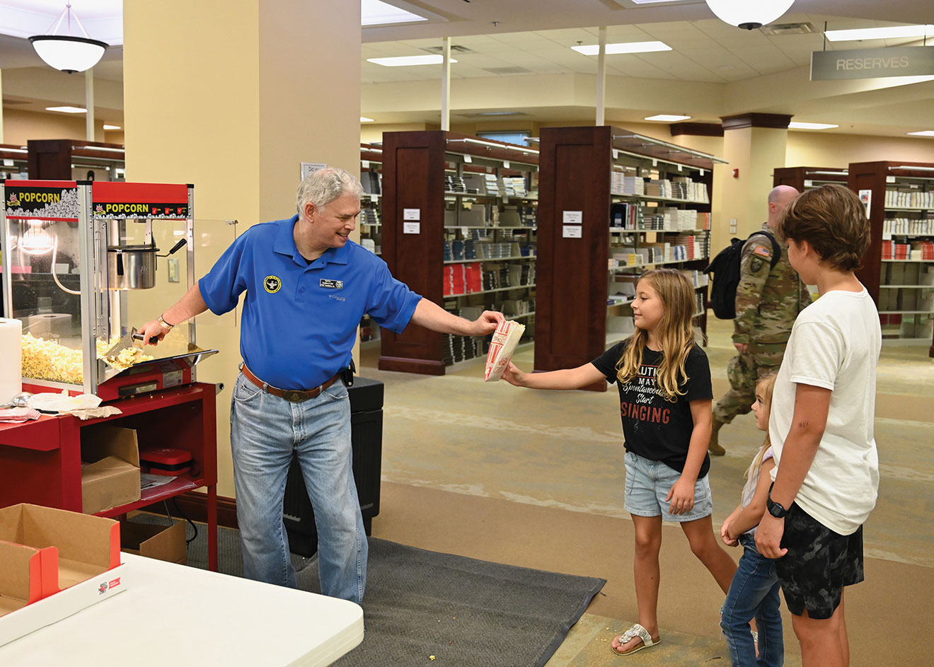 Foundation President/CEO Rod Cox manned the snack station providing popcorn, candy and water to all the families during the Ike Skelton Combined Arms Research Library open house on Aug. 11, 2023.