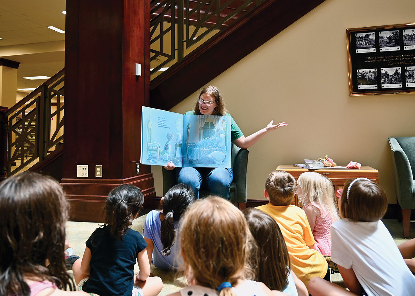 Library staff member Dawna Ofstehage reads “The Napping House” during a Storytime for kids during the Ike Skelton Combined Arms Research Library open house on Aug. 11, 2023.