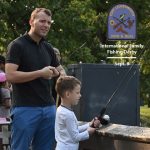 An international military student from the CGSC Class of 2022 and his son fish off the dock at Merritt Lake on Fort Leavenworth during the International Family Fishing Derby. This year's International Family Fishing Derby will be conducted Sept. 9, 2023.