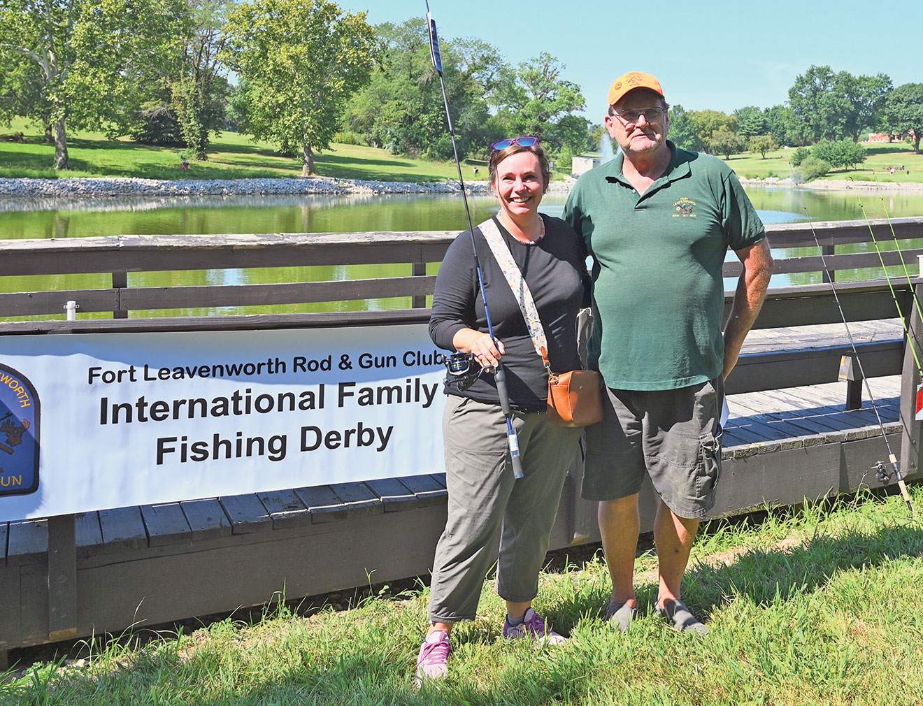 Larry Noell, president of the Fort Leavenworth Rod & Gun Club, presents Julia Van Dyke, wife of SAMS Class of 2024 international military student Maj. Ian Van Dyke from Canada, with a rod and reel combination for winning the Female Adult division at the International Family Fishing Derby Sept. 9, 2023, at Merritt Lake on Fort Leavenworth.