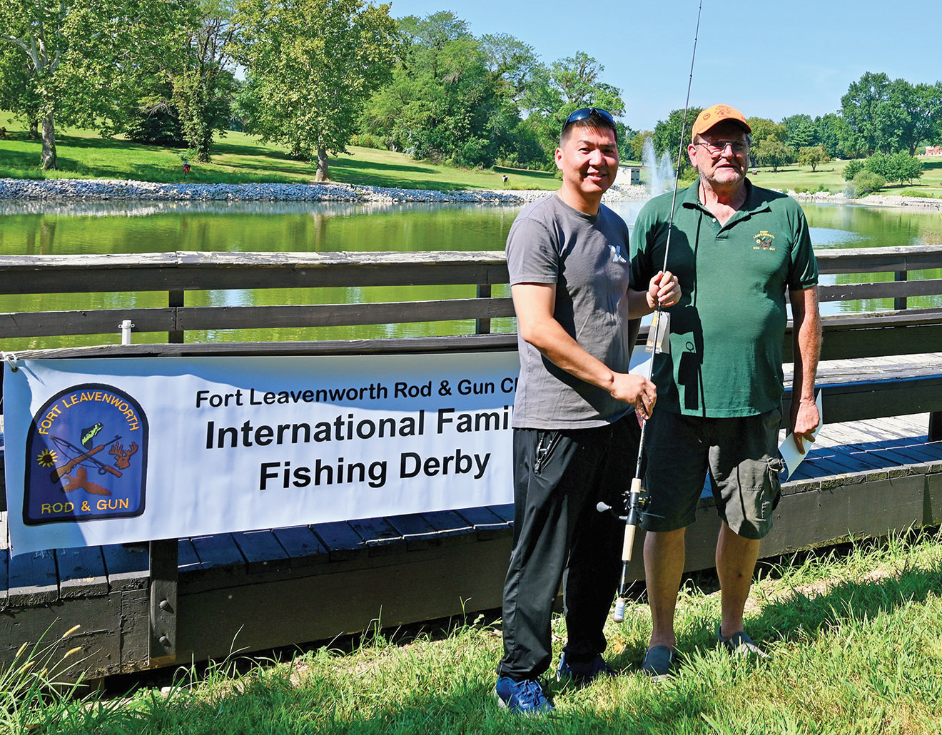 Larry Noell, president of the Fort Leavenworth Rod & Gun Club, presents Maj. Syergyei Bat-Erdene, Command and General Staff Officers Course Class of 2024 international military student from Mongolia, with a rod and reel combination for winning the Male Adult division at the International Family Fishing Derby Sept. 9, 2023, at Merritt Lake on Fort Leavenworth.