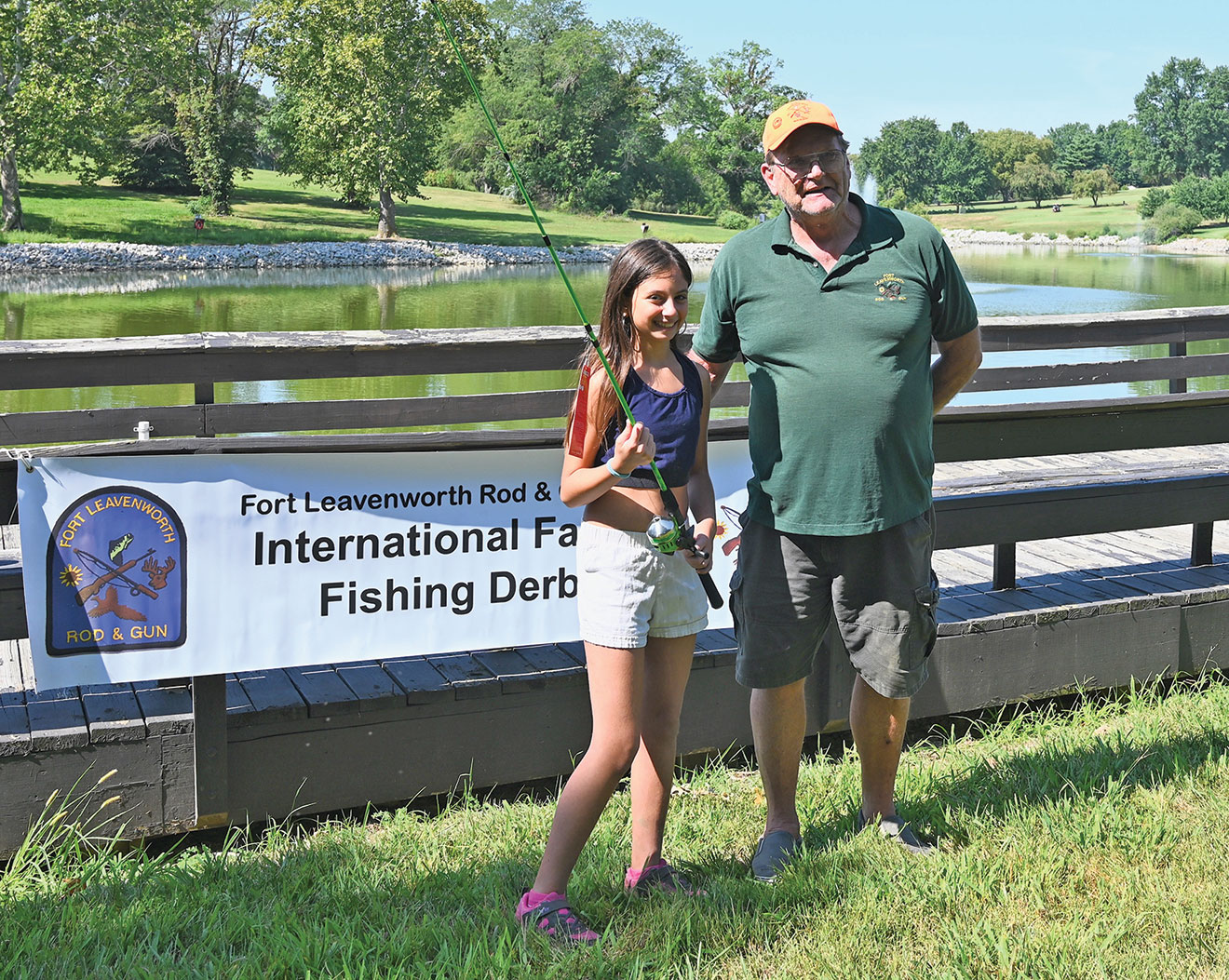 Larry Noell, president of the Fort Leavenworth Rod & Gun Club, presents Jenny Mouawad, daughter of Command and General Staff Officers Course Class of 2024 international military student Maj. George Mouawad from Lebanon., with a rod and reel combination for winning the Adult Female division at the International Family Fishing Derby Sept. 9, 2023, at Merritt Lake on Fort Leavenworth.