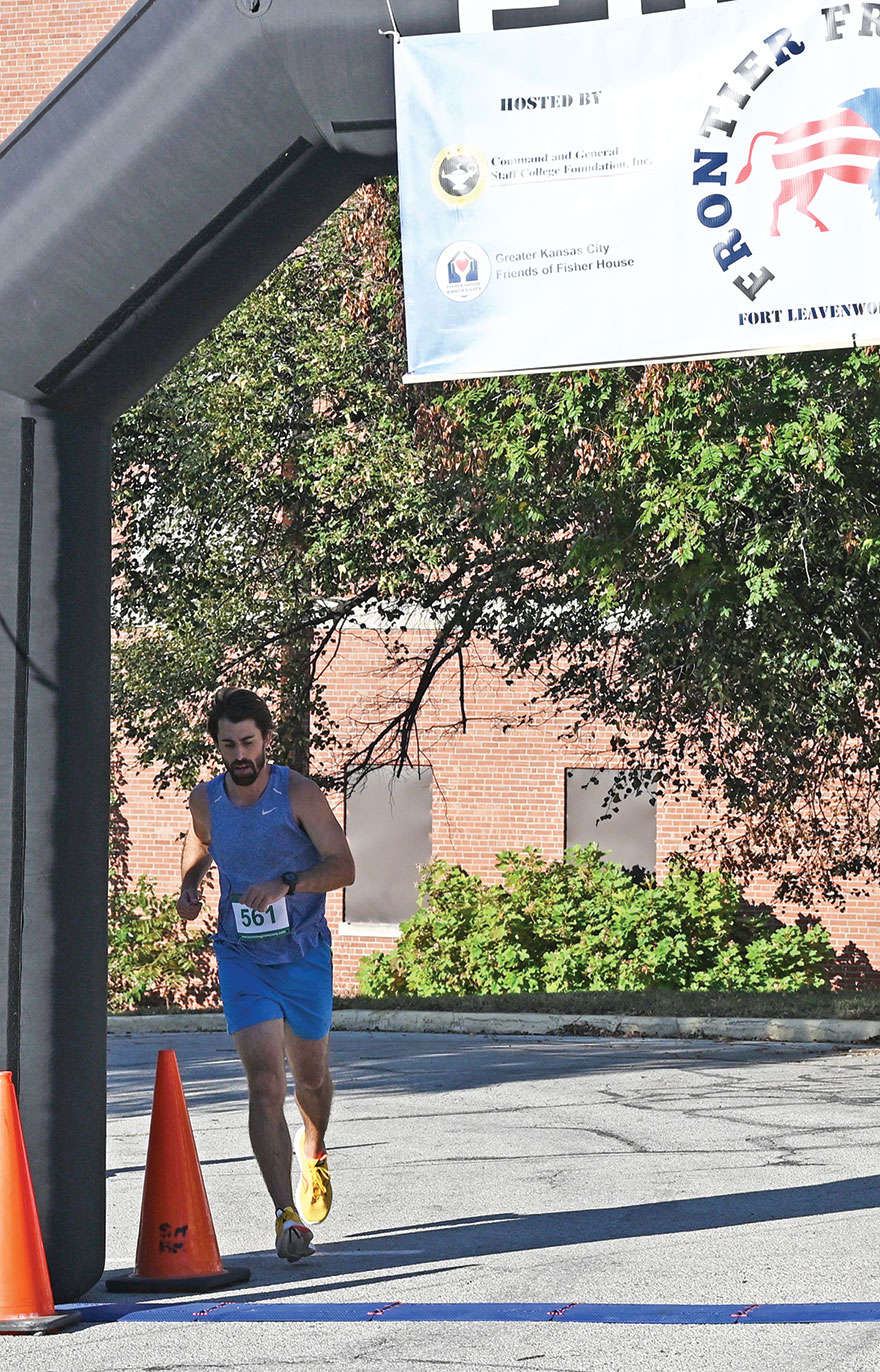 Jacob Bull crosses the finish line during the Frontier Freedom 5K Run/Walk on Fort Leavenworth on Oct. 8, 2023, hosted by the CGSC Foundation and the Greater Kansas City Friends of the Fisher House. Bull won the top overall and top male competition with a time of 18:53. 