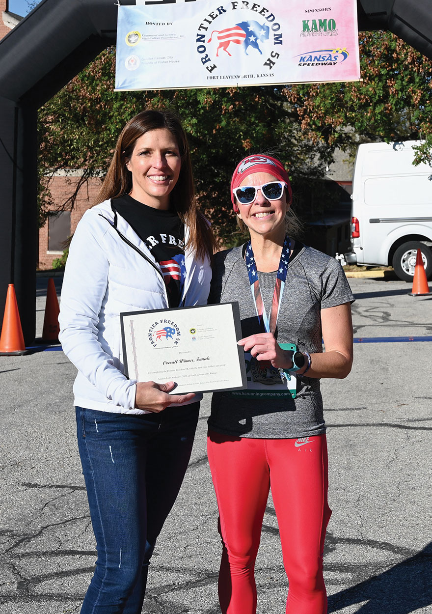 CGSC Foundation Interim President/CEO Lora Morgan, right, presents a certificate to Amanda Dopson for her fifth place overall and top female division finish in the Frontier Freedom 5K Run/Walk on Fort Leavenworth on Oct. 8, 2023. The race was hosted by the CGSC Foundation and the Greater Kansas City Friends of the Fisher House.
