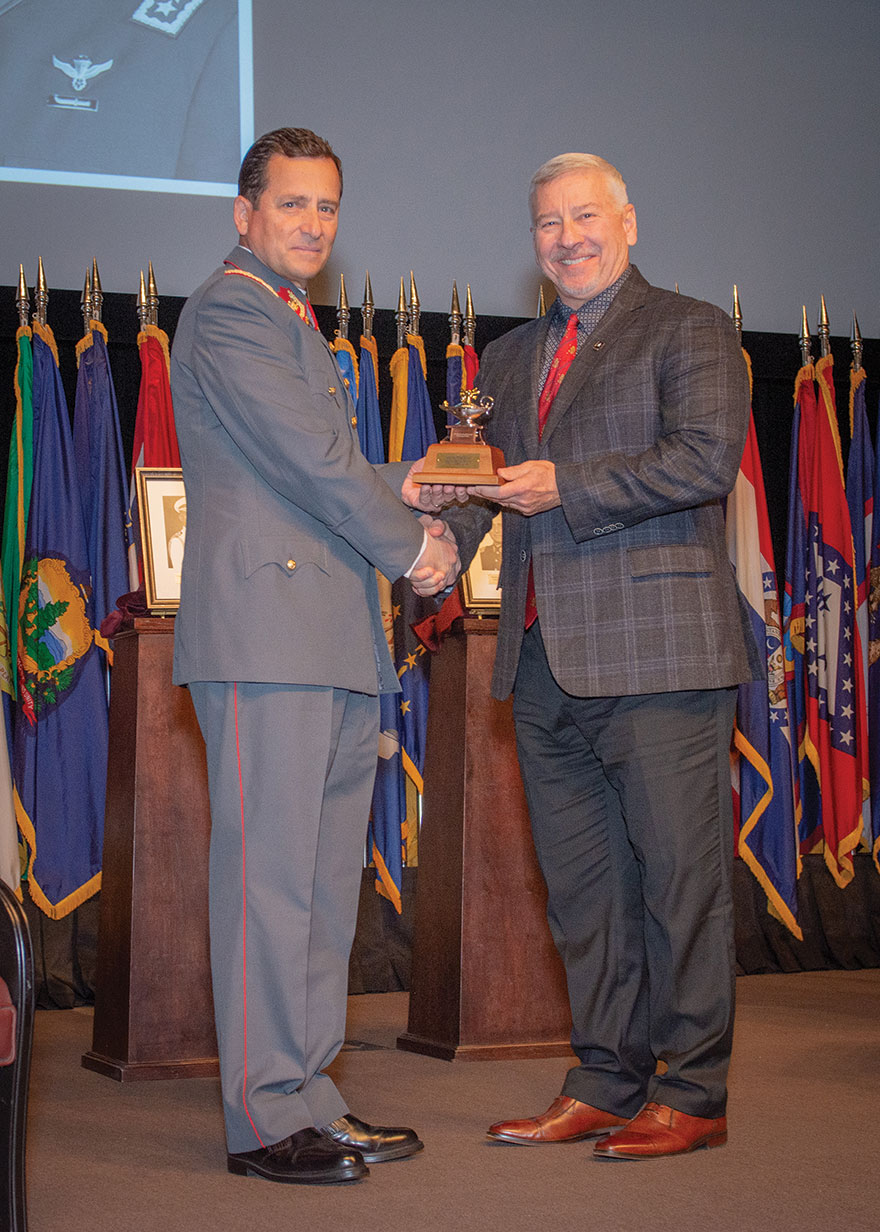 CGSC Foundation Chair Maj. Gen. (Ret.) Chris Hughes presents General Javier Iturriaga Del Campo, commander in chief of the Chilean Army, with a gift of a miniature Fort Leavenworth Lamp designating him as an honorary life constituent of the CGSC Foundation during the International Hall of Fame induction ceremony Oct. 31, 2023, at the Lewis and Clark Center, Fort Leavenworth, Kansas.