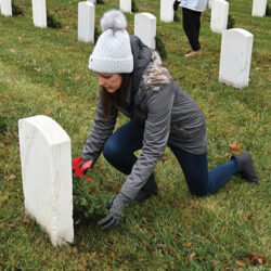 CGSC Foundation Interim President/CEO Lora Morgan places a wreath to honor a veteran on national Wreaths Across America Day, Dec. 16, 2023, at the Fort Leavenworth National Cemetery.
