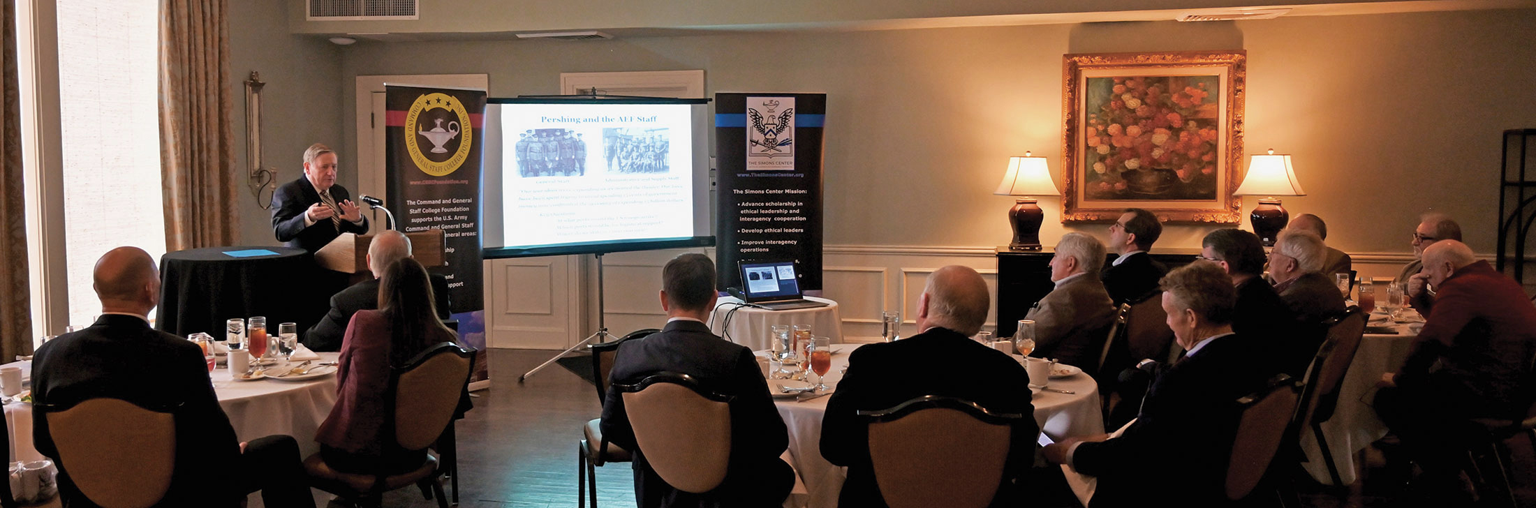 Col. (Ret.) Rolly Dessert provides a presentation on change management using the historical backdrop of Gen. John J. Pershing's efforts to organize the U.S. Army for World War I during the Arter-Rowland National Security Forum luncheon event on Jan. 18, 2024, at the Carriage Club in Kansas City.