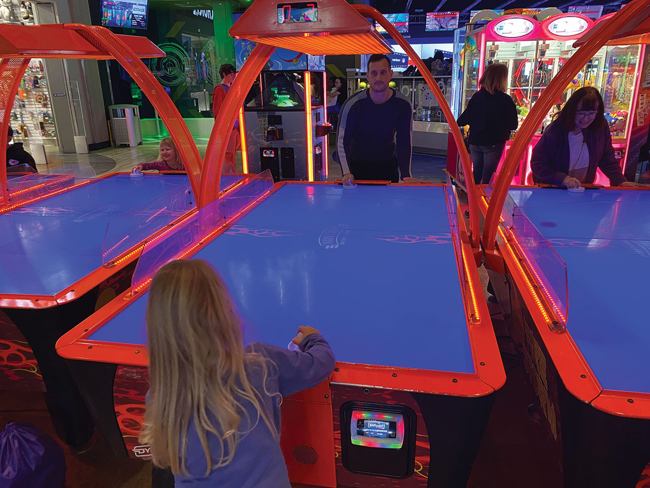 The IMS from Germany is outmatched by his daughter during a heated game of air hockey.