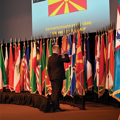 The North Macedonian officer in the CGSOC Class of 2025 posts and salutes his country's flag during the International Flag Ceremony conducted Aug. 5, 2024, in the Eisenhower Auditorium of the Lewis and Clark Center on Fort Leavenworth.